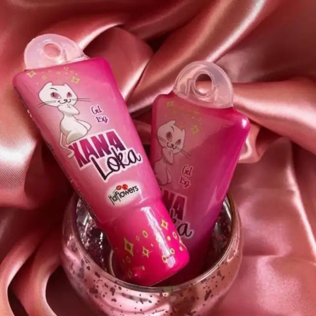 Hot Flowers Xana Loka Clitoral Stimulant Gel – Awaken Your Senses: Explosive Tingling with Jambu, 0.53 oz (15 g) – Two vibrant pink tubes of the stimulant gel with Jambu, elegantly presented in a shimmering glass on a silky pink background, highlighting the luxurious product aesthetic – Buy now at MKPBR.COM – Worldwide Shipping.