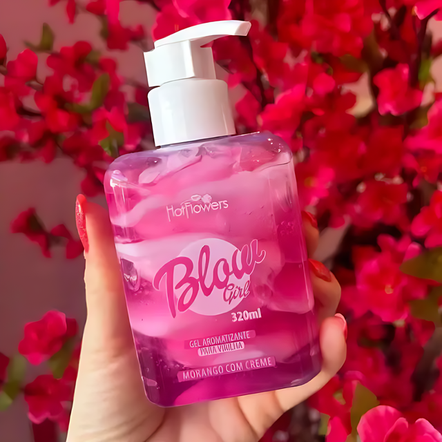 Hotflowers Blow Girl Intimate Aromatic Gel Strawberry & Cream 320ml – A hand gently holding the elegant square bottle of pink and white swirled gel against a soft, blurred pink floral background – Buy now at MKPBR.COM – Worldwide Shipping.
