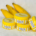 Adeus Dark Spot Correcting Cream for Intimate Areas and Body – 3.52 oz (100g). Product tube displayed with fresh bananas, highlighting natural banana extract for brightening – Buy now at MKPBR.COM – Worldwide Shipping