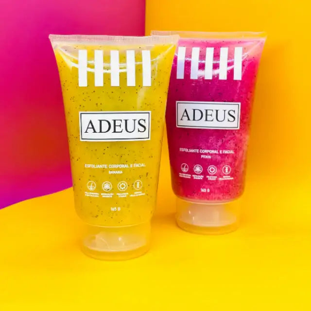 The Adeus Duo Exfoliator Kit with yellow banana and pink pitaya skin renewal and brightening scrubs, standing upright against a vibrant, modern split orange and pink background– Buy now at MKPBR.COM – Worldwide Shipping