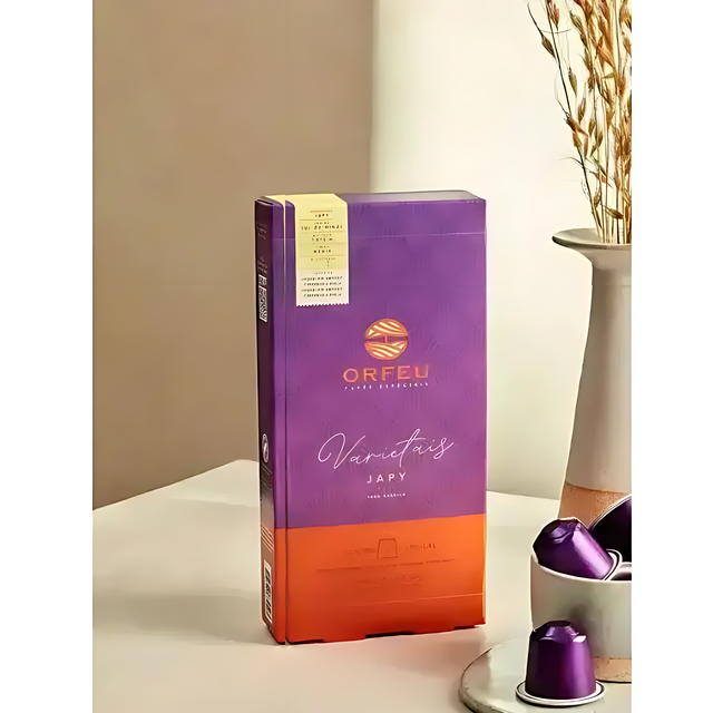 Orfeu Japy Nespresso Compatible Coffee Capsules - A dynamic image of Orfeu Japy capsules being taken from the box, illustrating convenience and readiness. – Buy now at MKPBR.COM – Worldwide Shipping