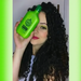 Model with curly hair holding Gold Spell Babosa & Azeite de Oliva 250ml for shine and definition - Buy now at MKPBR.COM - Worldwide Shipping