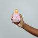 Boticário Boti Baby Lua Bath & After-Bath Baby Lotion pump bottle held in one hand, showing the compact 200 ml size and easy one-handed pump – Buy now at MKPBR.COM – Worldwide Shipping