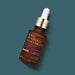 Botik Mandelic and Tranexamic Acid 5% facial serum by O Boticário, 30 ml amber bottle with gold collar angled on a deep teal background – Buy now at MKPBR.COM – Worldwide Shipping