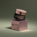Boticário Botik Resveratrol & Silicon Nourishing Face Cream jar balanced on its rose pink carton box in a green studio setting – Buy now at MKPBR.COM – Worldwide Shipping
