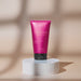 Brazilian O Boticário Coffee Woman Seduction liquid body soap 150 ml tube styled on a white fluted pedestal against a warm beige backdrop – Buy now at MKPBR.COM – Worldwide Shipping