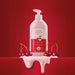 Boticário Cuide-se Bem Cereja de Fases body lotion bottle on a red background surrounded by glossy cherries and a creamy pink lotion pour – Buy now at MKPBR.COM – Worldwide Shipping