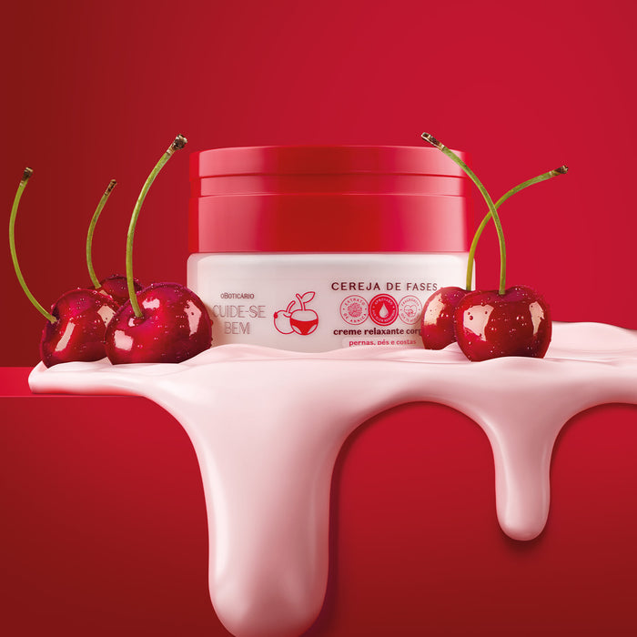 Boticário Cuide-se Bem Cereja de Fases body cream jar on a red background surrounded by fresh cherries and a pouring pink cream splash – Buy now at MKPBR.COM – Worldwide Shipping