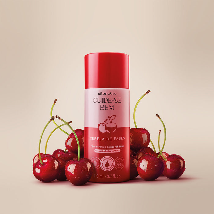 Boticário Cuide-se Bem Cereja de Fases Warming Body Oil 110 ml bottle surrounded by fresh cherries, cherry floral gourmand scent – Buy now at MKPBR.COM – Worldwide Shipping