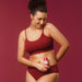 Woman massaging Boticário Cuide-se Bem Cereja de Fases Warming Body Oil over her abdomen for a comforting warm sensation – Buy now at MKPBR.COM – Worldwide Shipping