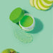 Open jar of Boticário Cuide-se Bem Feira facial gel moisturizer with a clear gel swatch and fresh green apple slices – Buy now at MKPBR.COM – Worldwide Shipping