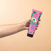 Hand holding the Boticário Cuide-se Bem Feira Pasta de Abacate avocado hair mask 250 ml tube against a peach gradient background – Buy now at MKPBR.COM – Worldwide Shipping