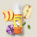 Boticario Dr. Botica Nuvem de Ideias Kids Bath Foam bottle styled with peach slices, apple and a violet flower illustrating its fruity aromatic fragrance – Buy now at MKPBR.COM – Worldwide Shipping