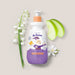 Boticário Dr. Botica Poção das Nuvens kids body lotion bottle in a beige flat lay with fresh green apple slices, lily of the valley stems and white blossoms – Buy now at MKPBR.COM – Worldwide Shipping