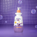 Boticário Dr. Botica Poção das Nuvens kids deodorant body lotion 400 ml bottle photographed against a purple tiled bathroom backdrop with floating soap bubbles – Buy now at MKPBR.COM – Worldwide Shipping