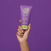 Hand holding the 5.07 fl oz Boticário Egeo Vanilla Ubesession deodorant body lotion tube against a purple background, showing the travel-friendly size – Buy now at MKPBR.COM – Worldwide Shipping
