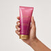 Hand holding the Boticário Glamour Intense Deodorant Body Lotion 200 ml tube for size reference – Buy now at MKPBR.COM – Worldwide Shipping