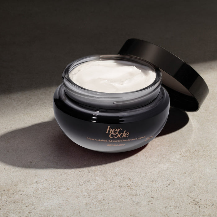 O Boticário Her Code Velvet Body Cream 250 g jar with the lid off, showing the dense white cream in natural sunlight – Buy now at MKPBR.COM – Worldwide Shipping