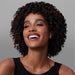 Smiling model with soft defined curls showcasing results of Boticário Match Deep Nutrition Brazilian hair mask – Buy now at MKPBR.COM – Worldwide Shipping