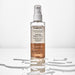 Brazilian Boticário Match Nutrição Regeneradora biphase leave-in hair oil 90 ml pump bottle on a white surface surrounded by water droplets – Buy now at MKPBR.COM – Worldwide Shipping