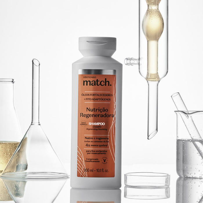 O Boticário Match. Nutrição Regeneradora Regenerating Shampoo 300 ml bottle styled with laboratory glassware and oil beakers, highlighting the scientifically tested Brazilian nourishing formula – Buy now at MKPBR.COM – Worldwide Shipping
