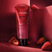 Brazilian Nativa SPA Morango Ruby Body Scrub 175 g tube on a red set with sliced strawberries – Buy now at MKPBR.COM – Worldwide Shipping