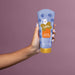 Hand holding the Boticário Sophie Kids Curl Definition Conditioner 200 ml tube to show its size and squeeze-tube format – Buy now at MKPBR.COM – Worldwide Shipping