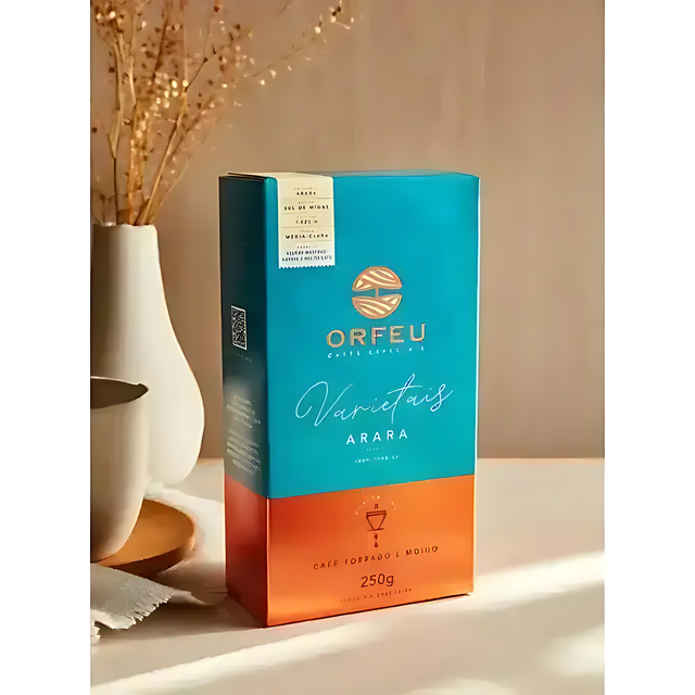 Orfeu Arara Ground Coffee- A freshly brewed cup of Orfeu Arara Ground Coffee, rich and golden-hued, surrounded by coffee beans on a natural wood surface. The image highlights the coffee's enticing aroma and smooth, medium-light roast profile.