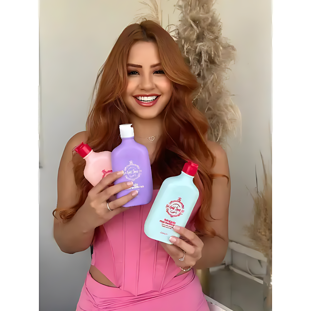 A smiling woman with radiant hair proudly holding the three Gold Spell Co. Cronoterapia hair masks (Hydration, Nutrition, Reconstruction) from the personalized treatment kit - Buy now at MKPBR.COM - Worldwide Shipping
