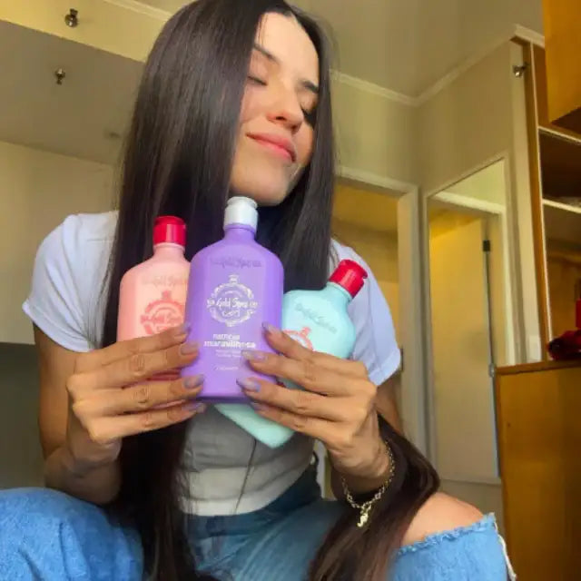 Woman with long dark hair, eyes closed in serenity, holding the three Gold Spell Co. Cronoterapia (Nutrition, Reconstruction, Hydration) hair masks – Buy now at MKPBR.COM - Worldwide Shipping