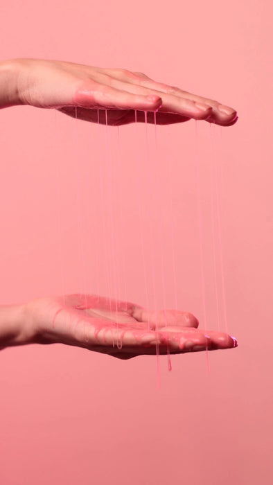 Rich pink cream texture of Gold Spell Everk Alisei Progressive Smoothing Treatment stretching between two hands – Buy now at MKPBR.COM – Worldwide Shipping