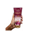 Hand holding the Paixão Framboesa Negra ultra-creamy deodorant moisturizing lotion tube, highlighting the new label and velvety touch promise. Buy now at MKPBR.COM – Worldwide Shipping