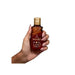 Bottle in hand showing compact size of Paixão Avelã (Hazelnut) deodorant body oil. Buy now at MKPBR.COM – Worldwide Shipping