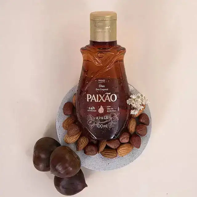 Amber bottle styled with hazelnuts and almonds, Paixão Avelã deodorant body oil. Buy now at MKPBR.COM – Worldwide Shipping