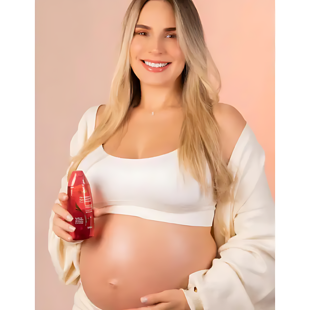 Muriel Rosehip & Collagen Body Oil | Hydrating & Firming Elixir | 3.38 fl oz (100ml) - Smiling pregnant woman touching her belly, highlighting stretch mark prevention and skin elasticity – Buy now at MKPBR.COM – Worldwide Shipping