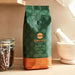 Orfeu Classic Whole Bean Coffee – 100% Arabica, Fruity, Chocolate & Caramel, Medium Roast – 8.82 oz (250g) – A close-up of Orfeu Classic whole coffee beans, highlighting their uniform size and rich brown color, ready for grinding. – Buy now at MKPBR.COM – Worldwide Shipping
