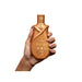 Hand holding Paixão Avelã 24H Hydrating Body Lotion, emphasizing ergonomic design and brand logo Buy now at MKPBR.COM – Worldwide Shipping