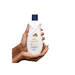 Paixão Inspiradora White Roses Moisturizing Body Lotion with Almond Oil, 13.53 oz (400 mL) - Gentle lotion bottle held, suitable for all skin types, deeply nourishing and soft – Buy now at MKPBR.COM – Worldwide Shipping