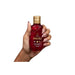 Paixão Tempting Ruby Plum deodorant body oil, 3.38 fl oz (100 mL), bottle held in hand for size reference. Buy now at MKPBR.COM – Worldwide Shipping