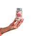 Hand holding a bottle of Popozuda Blend skin capsules moisturizer with pink label and silver cap