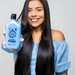 Model with long straight hair holding Receitinha Obrigatoria By Gold Spell Co 250ml hair cream – Buy now at MKPBR.COM – Worldwide Shipping