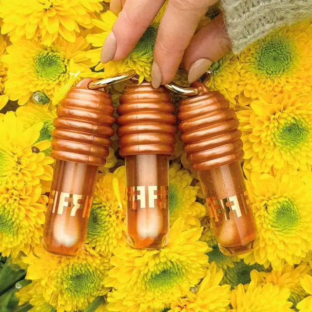A trio of Fran by Franciny Ehlke Lip Honey Lip Glosses, showcasing the collection for extended radiance – Buy now at MKPBR.COM – Worldwide Shipping