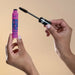Vult Extreme Bombastic! Waterproof Mascara elegantly held in hands, showcasing its bright pink tube and black wand, ready for captivating application – Buy now at MKPBR.COM – Worldwide Shipping