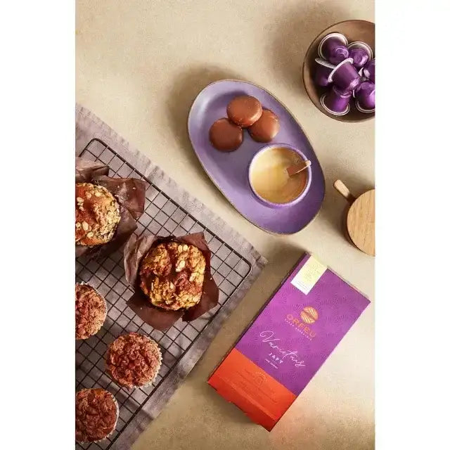 Orfeu Japy Nespresso Compatible Coffee Capsules- A lifestyle shot of Orfeu Japy capsules arranged in a neat coffee table, with pastries and chocolate, enhancing a modern home experience. – Buy now at MKPBR.COM – Worldwide Shipping