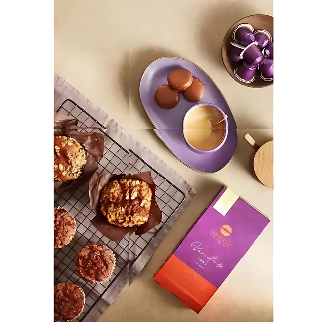 Orfeu Japy Nespresso Compatible Coffee Capsules- A lifestyle shot of Orfeu Japy capsules arranged in a neat coffee table, with pastries and chocolate, enhancing a modern home experience. – Buy now at MKPBR.COM – Worldwide Shipping